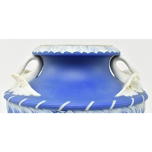 58 - A 19th century Wedgwood blue Jasperware Leda & Swan urn vase. The urn having a flared rim over t... 