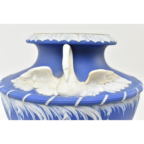 58 - A 19th century Wedgwood blue Jasperware Leda & Swan urn vase. The urn having a flared rim over t... 