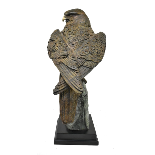 6 - A cast bronze figured sculpture of an eagle. The eagle depicted sitting atop a handler's gloved hand... 