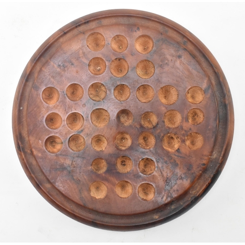 83 - A figured walnut solitaire circular board with polished hardstone geological specimen marbles. The b... 