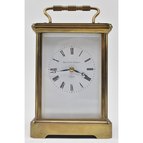 84 - Matthew Norman - an early 20th century Swiss made brass carriage clock. The clock of typical form, b... 