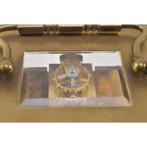 84 - Matthew Norman - an early 20th century Swiss made brass carriage clock. The clock of typical form, b... 