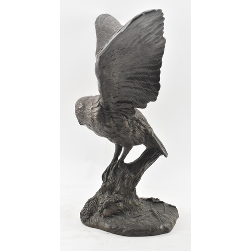 87 - Jeanne Rynhart (Irish, 1946-2020) - a 20th century large bronzed resin sculpture of a barn owl. The ... 