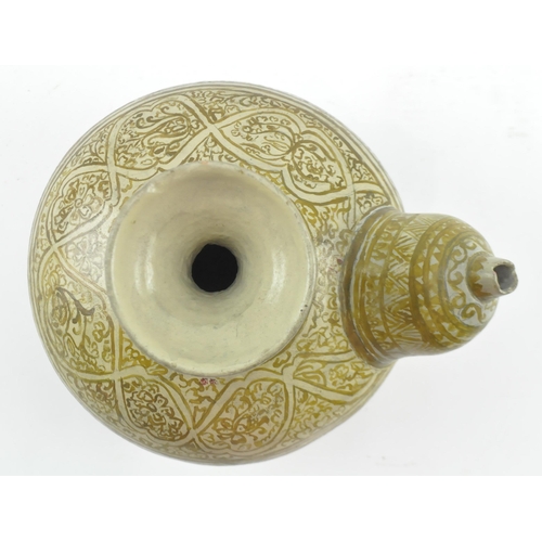 136 - A South Eastern Thai Sawankhalok kendi, the ceramic globular body with mammiform spout, beneath a fl... 