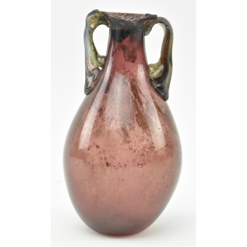 30 - A Roman aubergine glass flask vase circa 1st - 3rd century AD. A finely modelled Ancient Roman trans... 