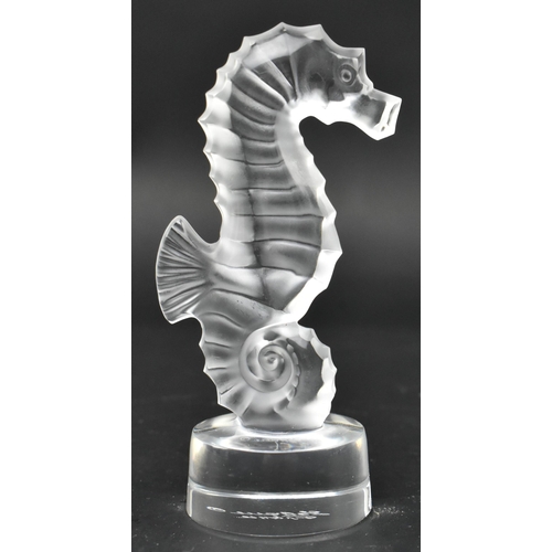 104 - Lalique, France - a glass seahorse paperweight. The hippocampe seahorse frosted and raised on a circ... 