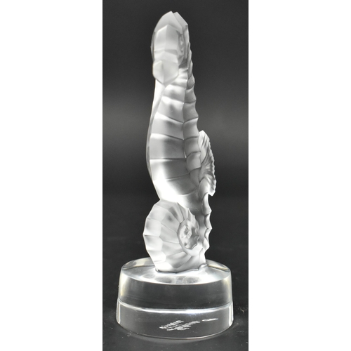 104 - Lalique, France - a glass seahorse paperweight. The hippocampe seahorse frosted and raised on a circ... 