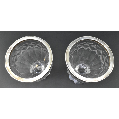 118 - A pair of early 19th century cut glass and silver plated condiment pots. Each with silver plated cir... 