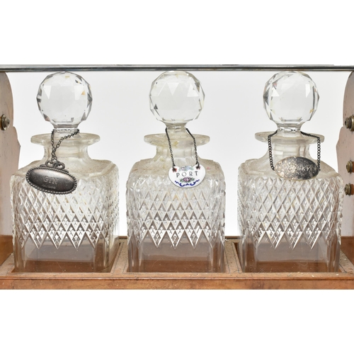 156 - A Victorian late 19th century oak & silver plated three decanters tantulus. The tantulus having ... 