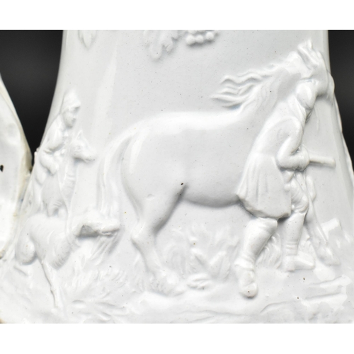 176 - A Victorian 19th century white salt glazed pitcher. The jug relief moulded with hunting scenes with ... 