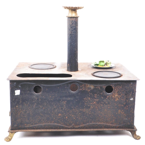 181 - A 19th century German Bavarian tin and brass plate table top children's stove. The stove having thre... 