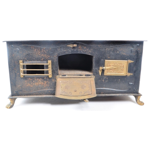 181 - A 19th century German Bavarian tin and brass plate table top children's stove. The stove having thre... 