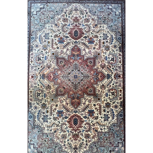 264 - A Persian Heriz hand woven wool floor carpet rug. The carpet having a central pink medallion of geom... 