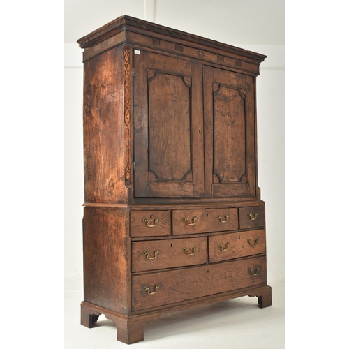 267 - An 18th century oak & marquetry inlaid livery cupboard press. The cupboard having a flared pedim... 