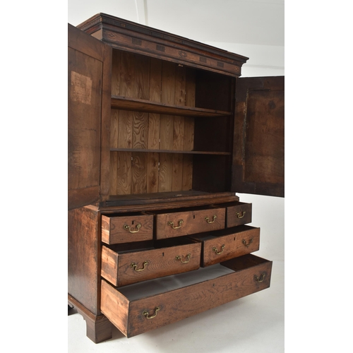 267 - An 18th century oak & marquetry inlaid livery cupboard press. The cupboard having a flared pedim... 