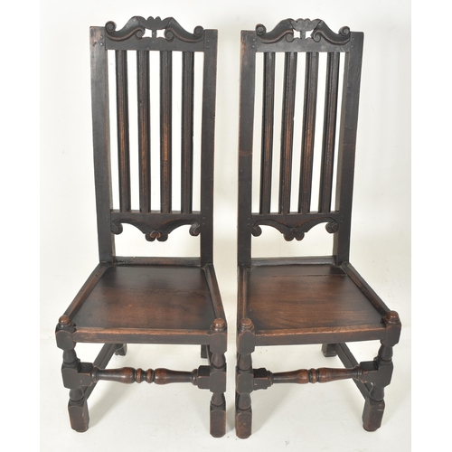 279 - A pair of Carolean 17th century carved oak railed back hall - dining chairs. Each having a carved sc... 