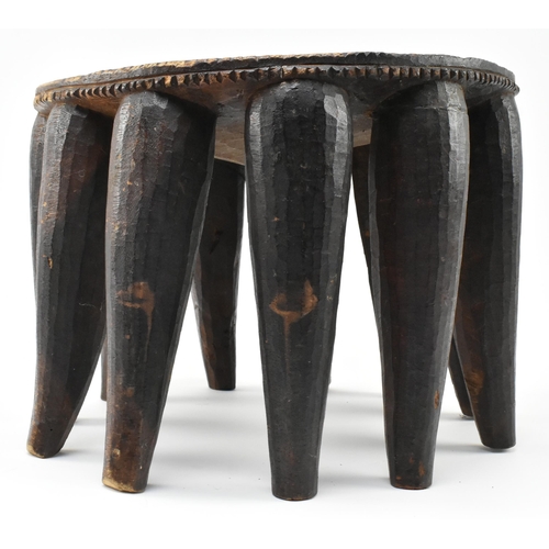 287 - A 20th century African Nigerian tribal hand carved hardwood Nupe stool. The stool featuring central ... 