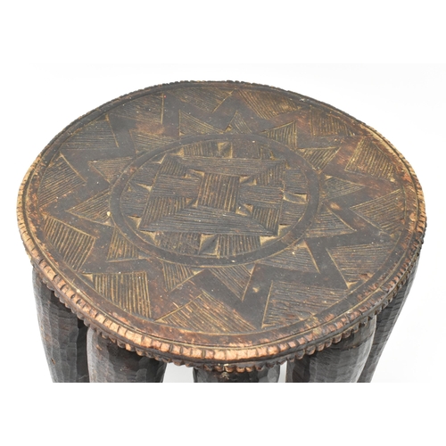 287 - A 20th century African Nigerian tribal hand carved hardwood Nupe stool. The stool featuring central ... 