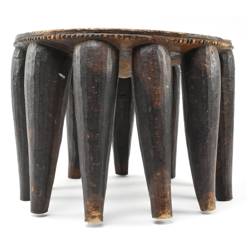 287 - A 20th century African Nigerian tribal hand carved hardwood Nupe stool. The stool featuring central ... 