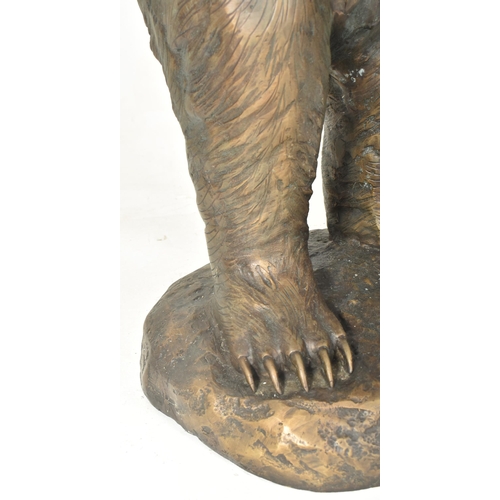 291 - A Black Forest manner early 20th century hollow cast bronze floor standing figure of bear. The bear ... 