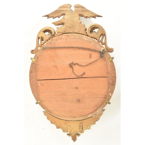 293 - A 19th century Regency style gilt wood & gesso worked convex eagle wall hanging mirror. The mirr... 