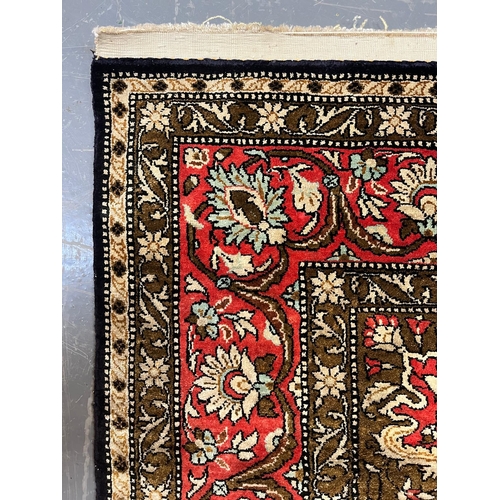 301 - A Persian Ghom Province 100% silk floor carpet rug. The carpet having a central yellow & red flo... 