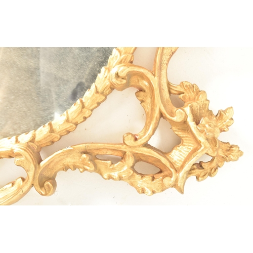 302 - A Rococo inspired French 19th century carved giltwood wall hanging mirror. The mirror having an intr... 