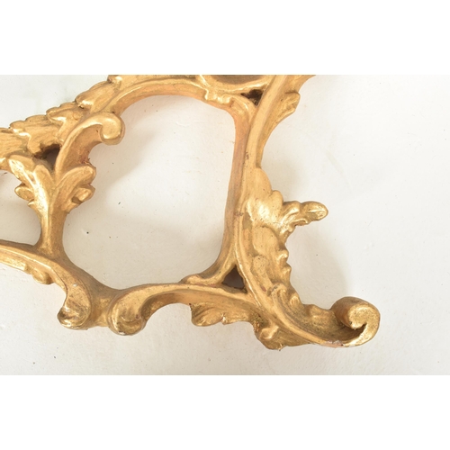 302 - A Rococo inspired French 19th century carved giltwood wall hanging mirror. The mirror having an intr... 