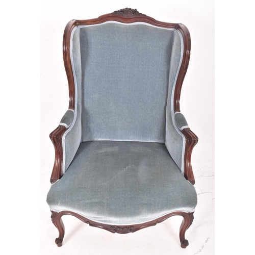 305 - A Victorian 19th century mahogany framed & velvet upholstered wingback armchair. The armchair ha... 