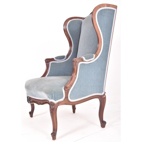 305 - A Victorian 19th century mahogany framed & velvet upholstered wingback armchair. The armchair ha... 