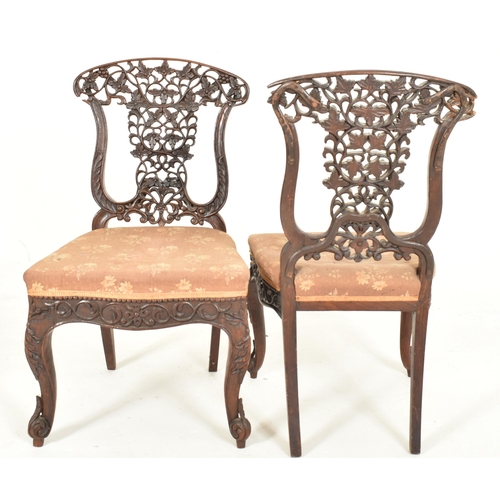 307 - A pair of Anglo-Colonial Indian 19th century carved hardwood chairs. Each chair having a scrolled ba... 