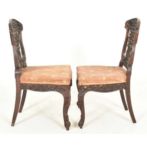 307 - A pair of Anglo-Colonial Indian 19th century carved hardwood chairs. Each chair having a scrolled ba... 