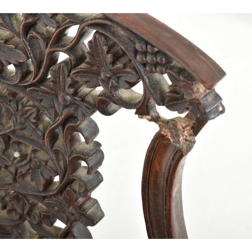 307 - A pair of Anglo-Colonial Indian 19th century carved hardwood chairs. Each chair having a scrolled ba... 