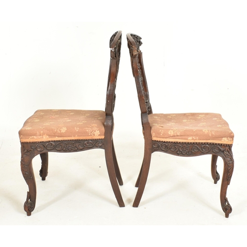 307 - A pair of Anglo-Colonial Indian 19th century carved hardwood chairs. Each chair having a scrolled ba... 