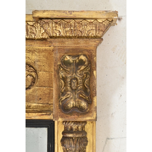 308 - A Regency early 19th century gilt wood & gesso worked overmantel mirror. The mirror having a fla... 