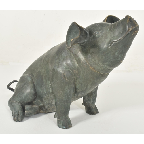 310 - A large late 20th century cast bronze worked floor standing pig statue sculpture. The pig shown seat... 