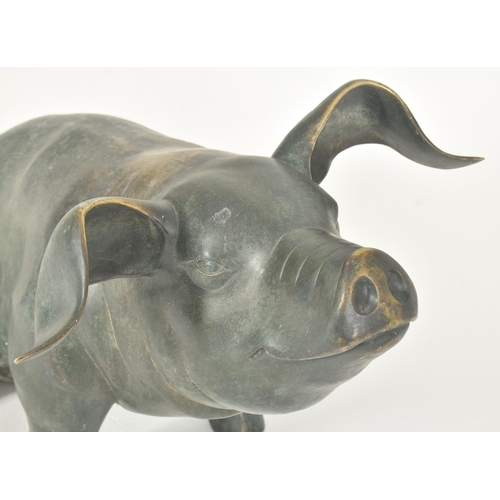 310 - A large late 20th century cast bronze worked floor standing pig statue sculpture. The pig shown seat... 