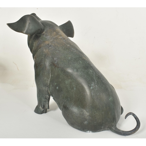 310 - A large late 20th century cast bronze worked floor standing pig statue sculpture. The pig shown seat... 