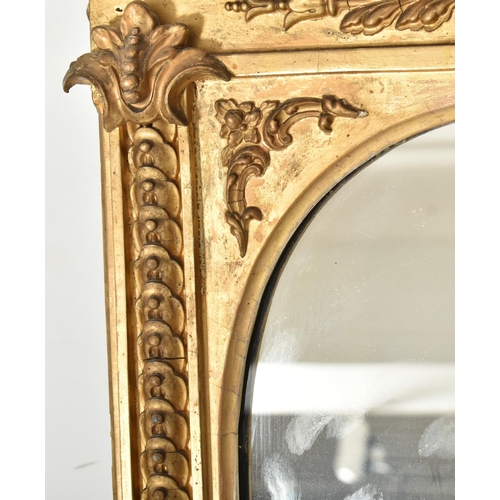 314 - A Victorian 19th century gilt wood & gesso worked overmantel mirror. The mirror having an intric... 