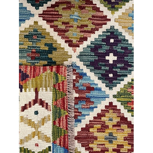 316 - A 20th century Anatolian Turkish Islamic Kilim floor carpet rug. The rug having a central panel with... 