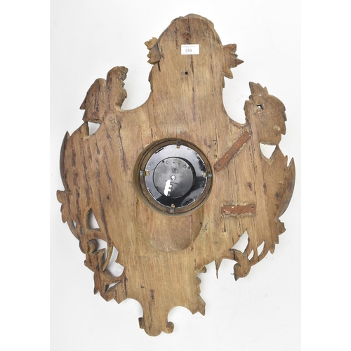 319 - A continental Black Forest early 20th century carved oak wall hanging clock. The clock having a deer... 