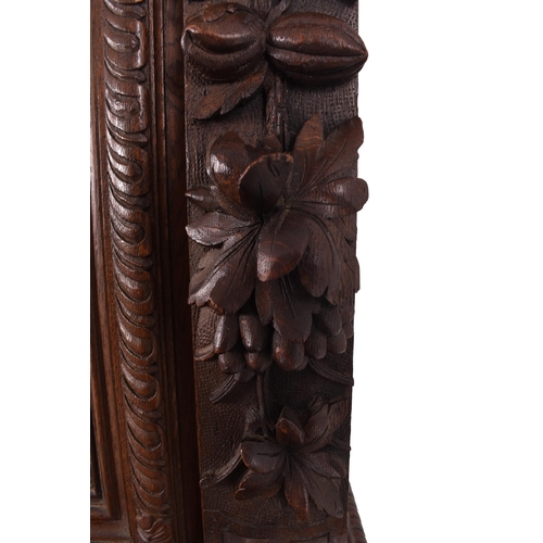 326 - A 19th century carved oak library bookcase cabinet. The bookcase having a twin door glazed top with ... 