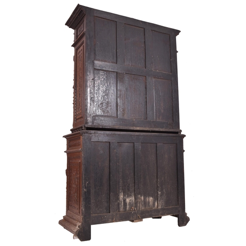 326 - A 19th century carved oak library bookcase cabinet. The bookcase having a twin door glazed top with ... 