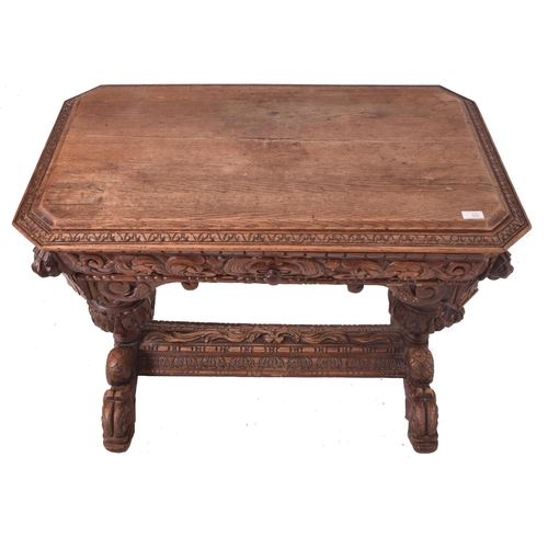 328 - A 19th century carved oak library writing table desk. The table having a chamfered edge top over a c... 