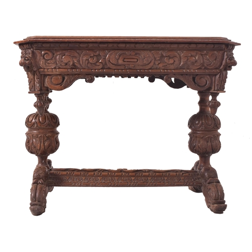 328 - A 19th century carved oak library writing table desk. The table having a chamfered edge top over a c... 