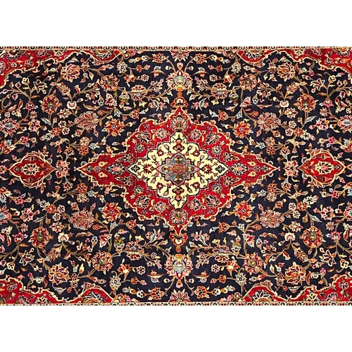 329 - A 20th century Central Persian Islamic Kashan floor carpet rug. The carpet having a central red &... 