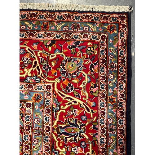 329 - A 20th century Central Persian Islamic Kashan floor carpet rug. The carpet having a central red &... 