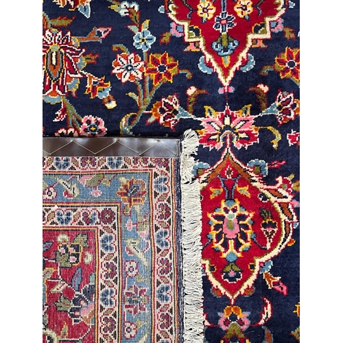 329 - A 20th century Central Persian Islamic Kashan floor carpet rug. The carpet having a central red &... 