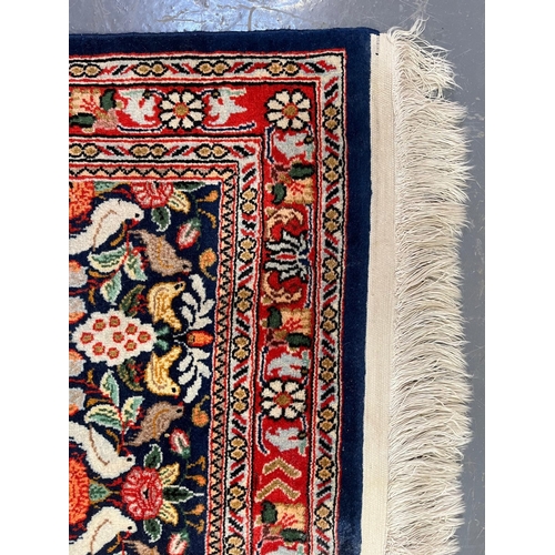 334 - A Persian Kashan pictorial wool floor carpet runner rug. The runner rug having a central cobalt blue... 