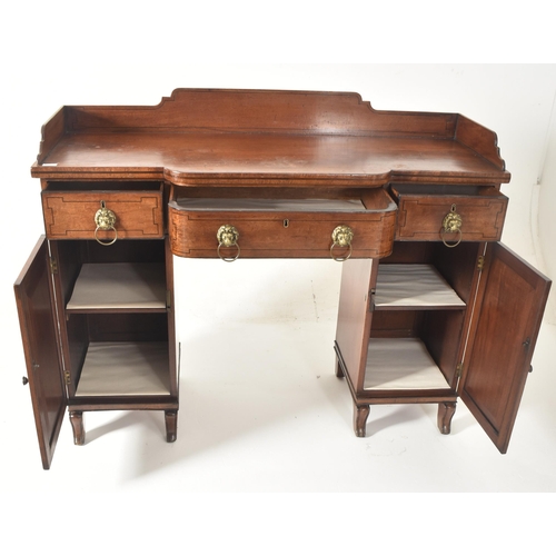 342 - A George III early 19th century mahogany breakfront pedestal writing desk table. The desk having a s... 